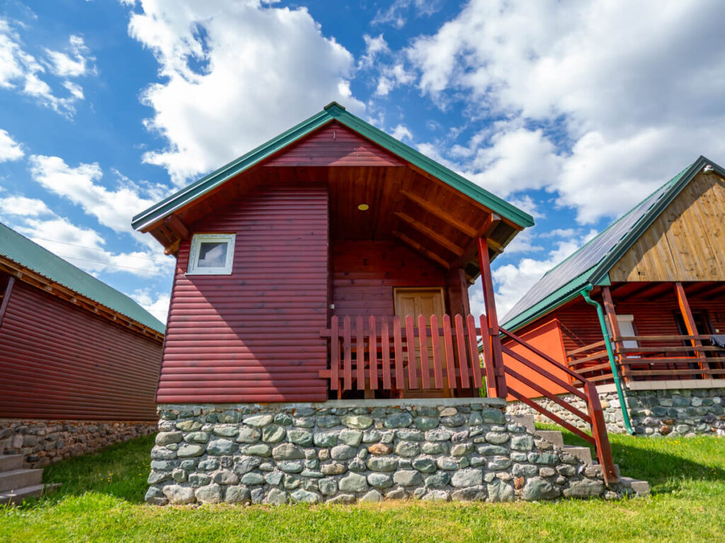 A wooden cabin standing proudly against the blue sky at Eco Village Coric near Biogradska Gora.