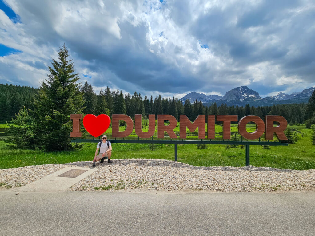 Dan crouching by the I heart Durmitor sign.
