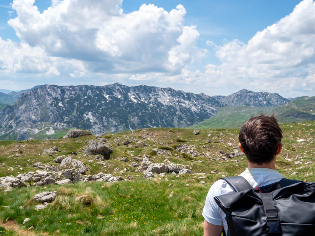 Dan looking at the view of expansive mountains from the Bobotov Kuk trail.