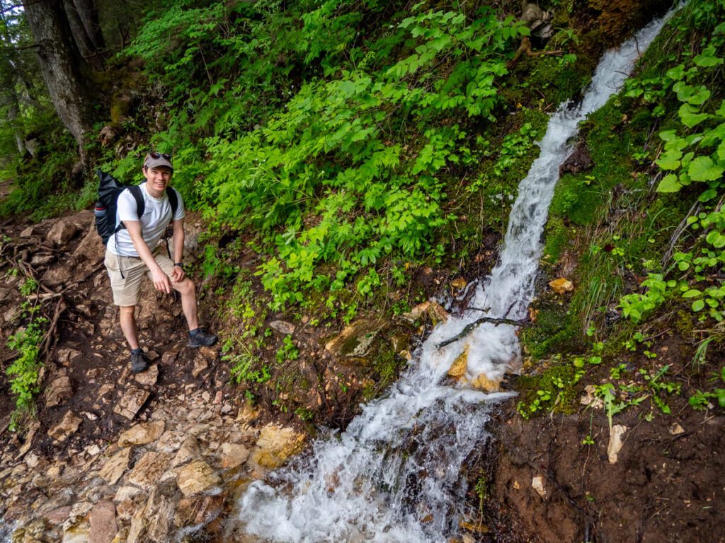 Dan pointing at a small waterfall crossing on the Black Lake hiking trail in Durmitor National Park.
