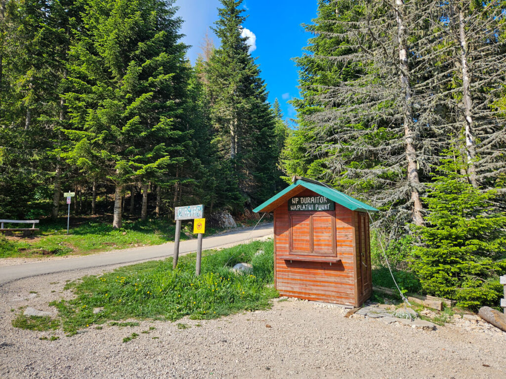 A wooden ticket booth marking the entrance to Durmitor National Park at the start of the Ćurevac Trail.