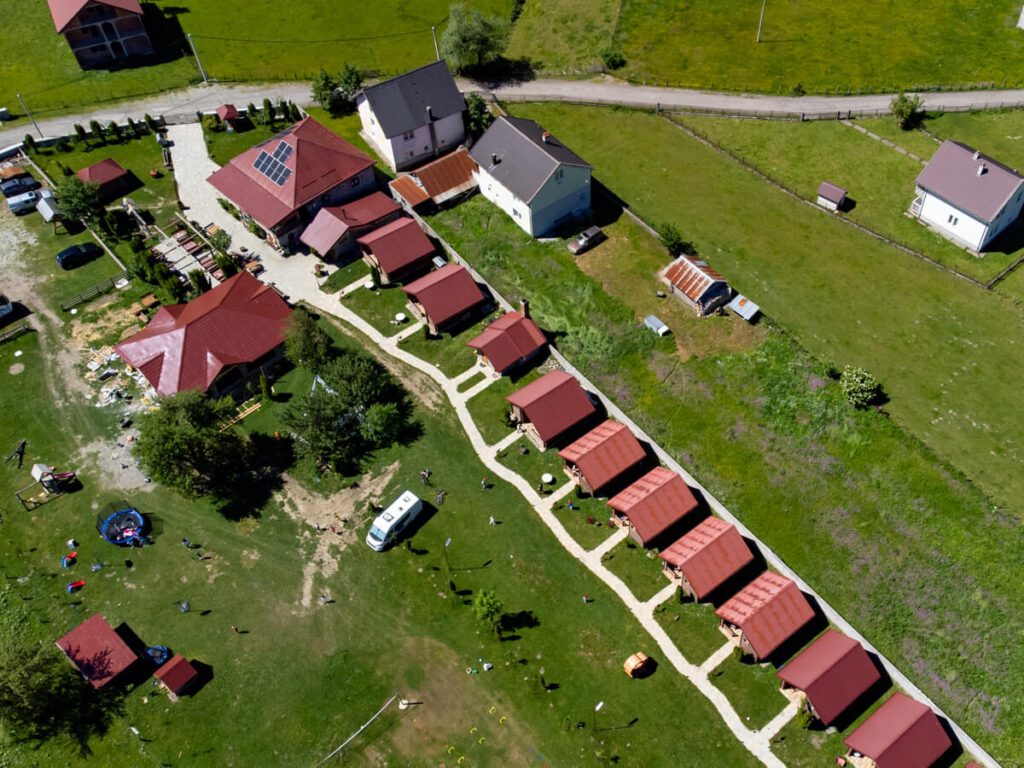 A drone view of a row of cabins leading to the restaurant at Eko Katun Rosi.