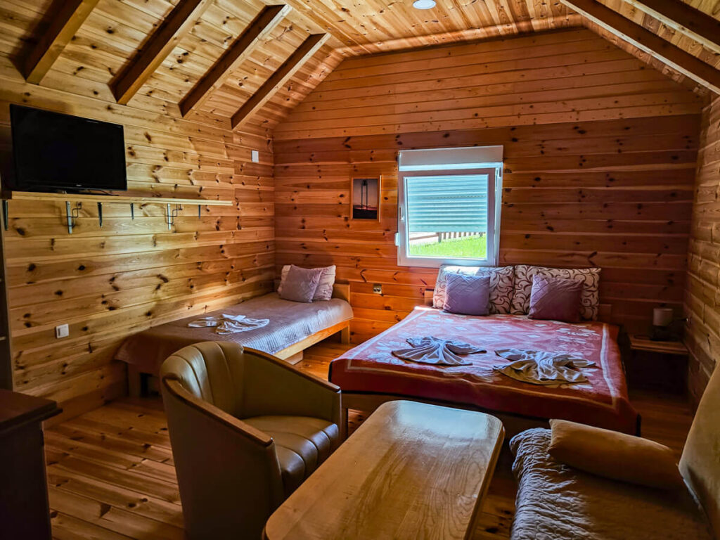 The warm interior of a wooden cabin at Eco Village Coric near Biogradska Gora National Park.
