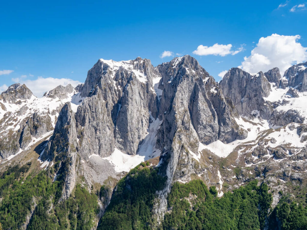 The towering jagged limestone peaks of the Karanfili Massif in Prokletije National Park dusted in snow.