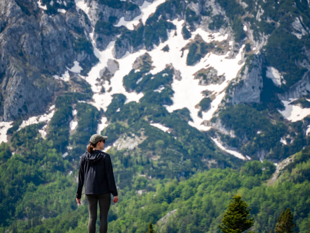 Lucy looking at snowy mountains from a viewpoint on the Durmitor Ring Road.