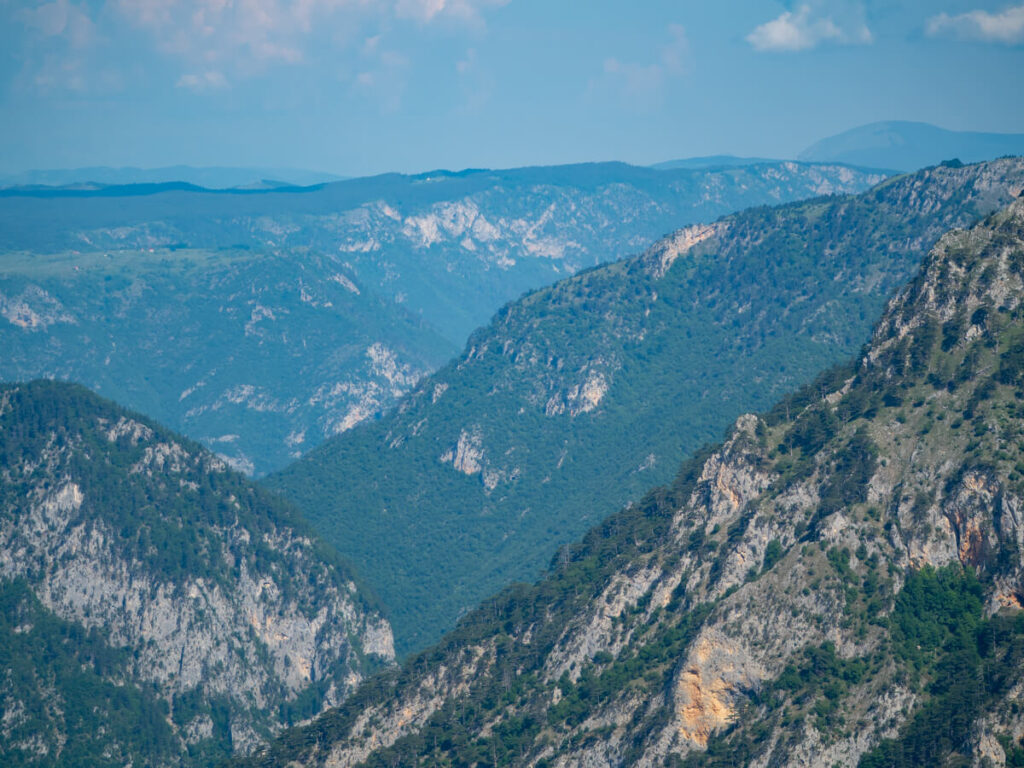 Layers of dramatic limestone mountains in the Tara River Canyon, viewed from Ćurevac Peak.