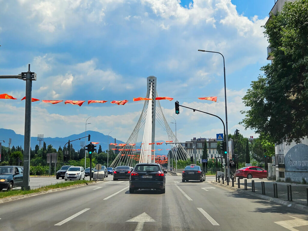 Traffic on a three-lane highway through Podgorica leading to the Millennium Bridge.