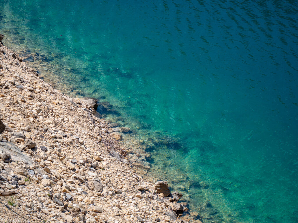 Shallow water at the rocky edge of Piva Lake.
