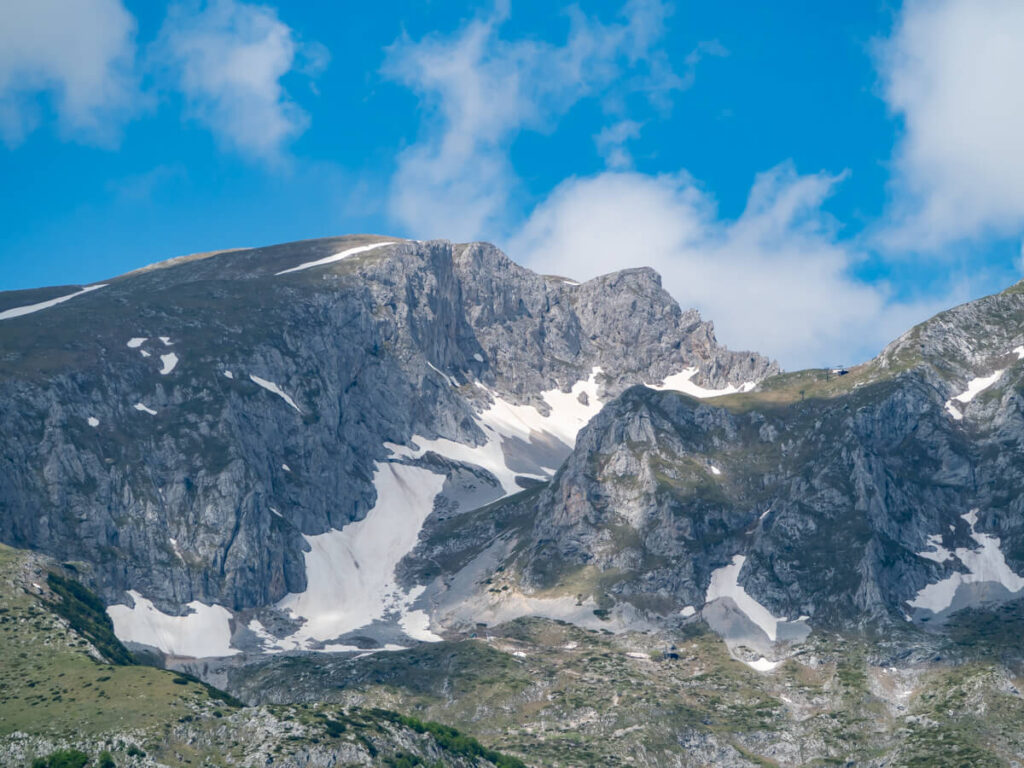 Snow lingering on the grey peak of Savin Kuk in Durmitor National Park.