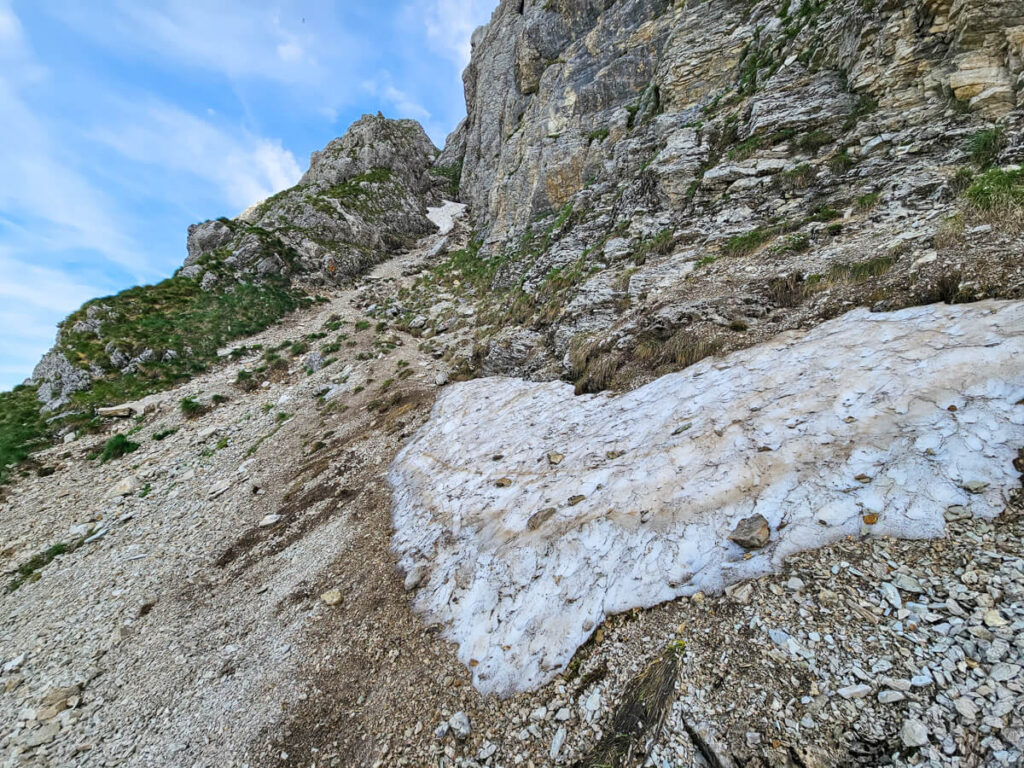 Snow covering a narrow scree-covered trail on the Bobotov Kuk hike.