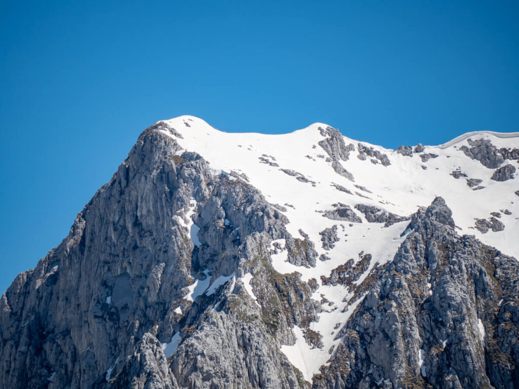 Snow atop a jagged limestone peak in the Karanfili Massif, viewed from the Three Peaks hike in Prokletije National Park.