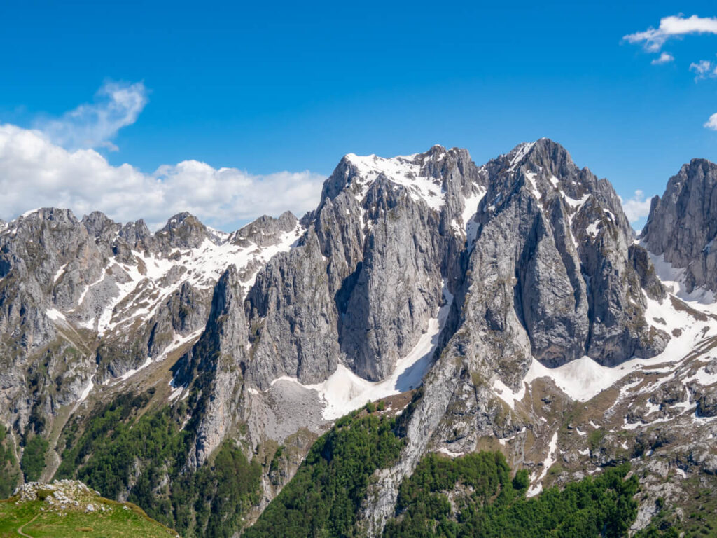 Jagged limestone peaks of the Karanfili Massif covered in snow in Prokletije National Park.