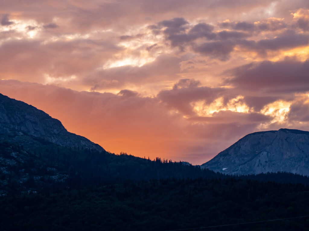 A blazing pink and orange sunset over the mountains in Durmitor National Park.