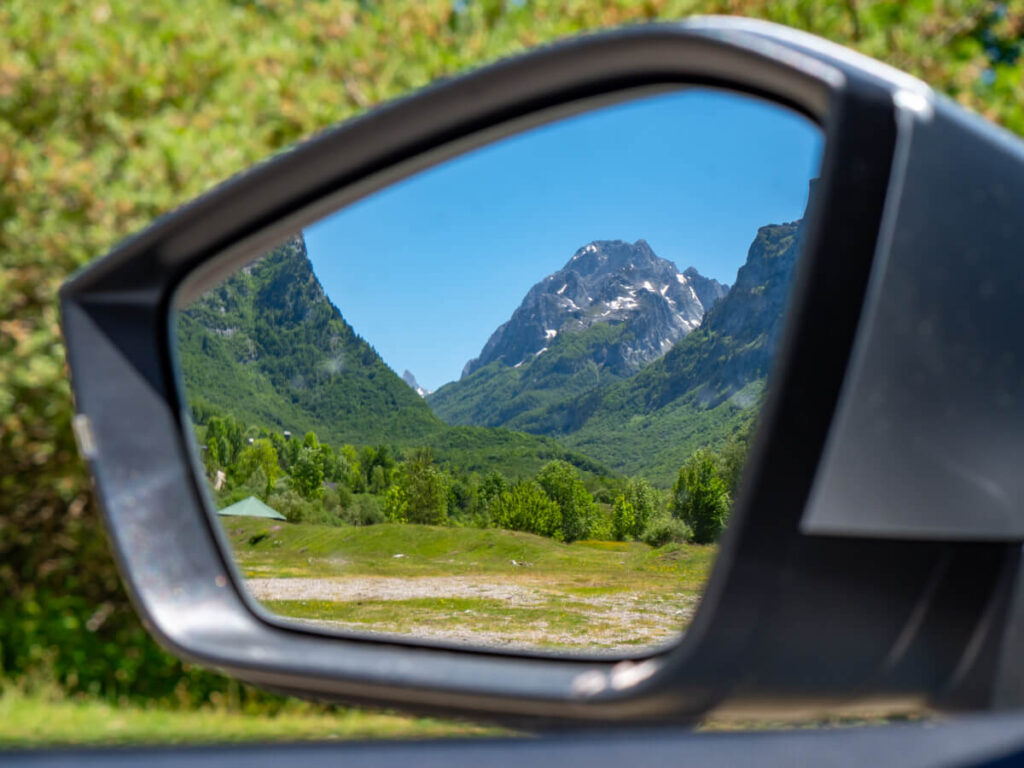 A mountain reflected in the wingmirror of a car in Montenegro.