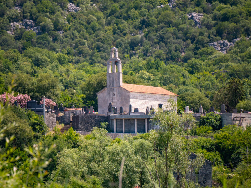 Dodoši Church, surrounded by lush greenery.