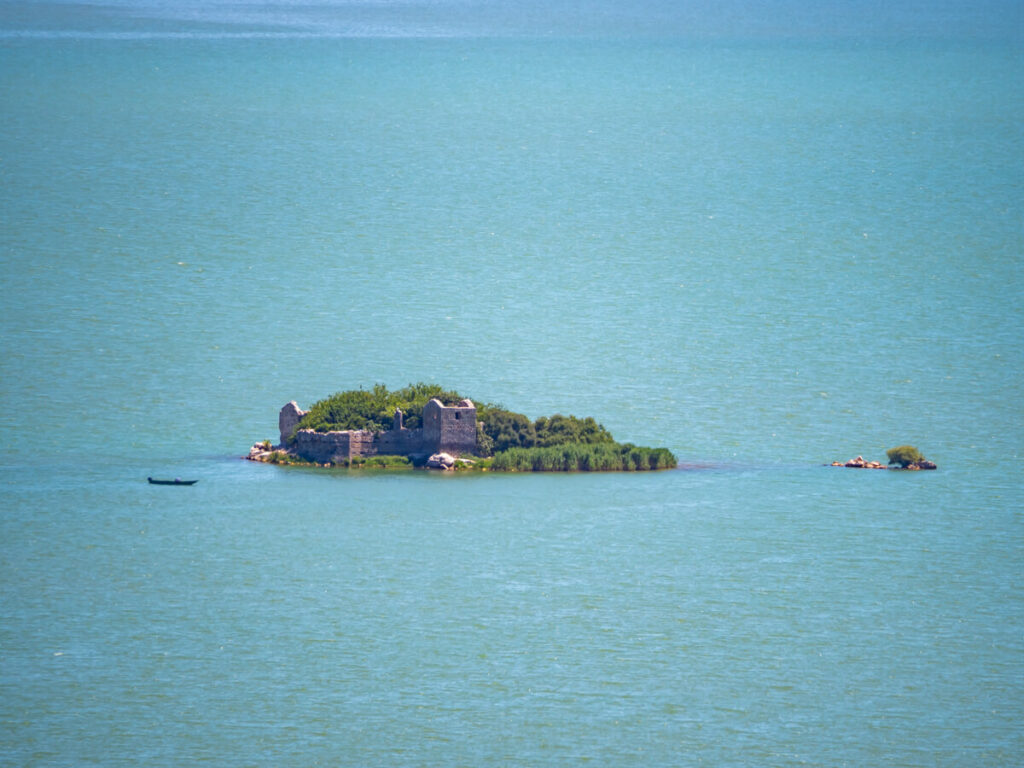 Grmozur Island surrounded by the glossy blue waters of Lake Skadar.