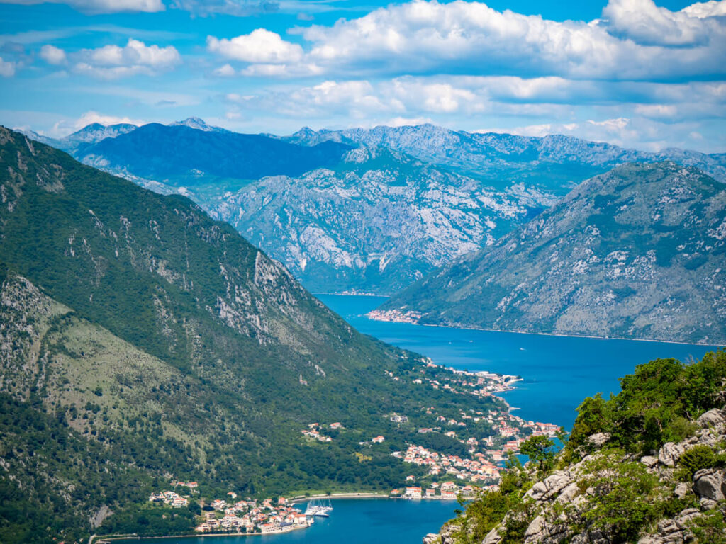 The blue waters of the Bay of Kotor winding between green mountains.