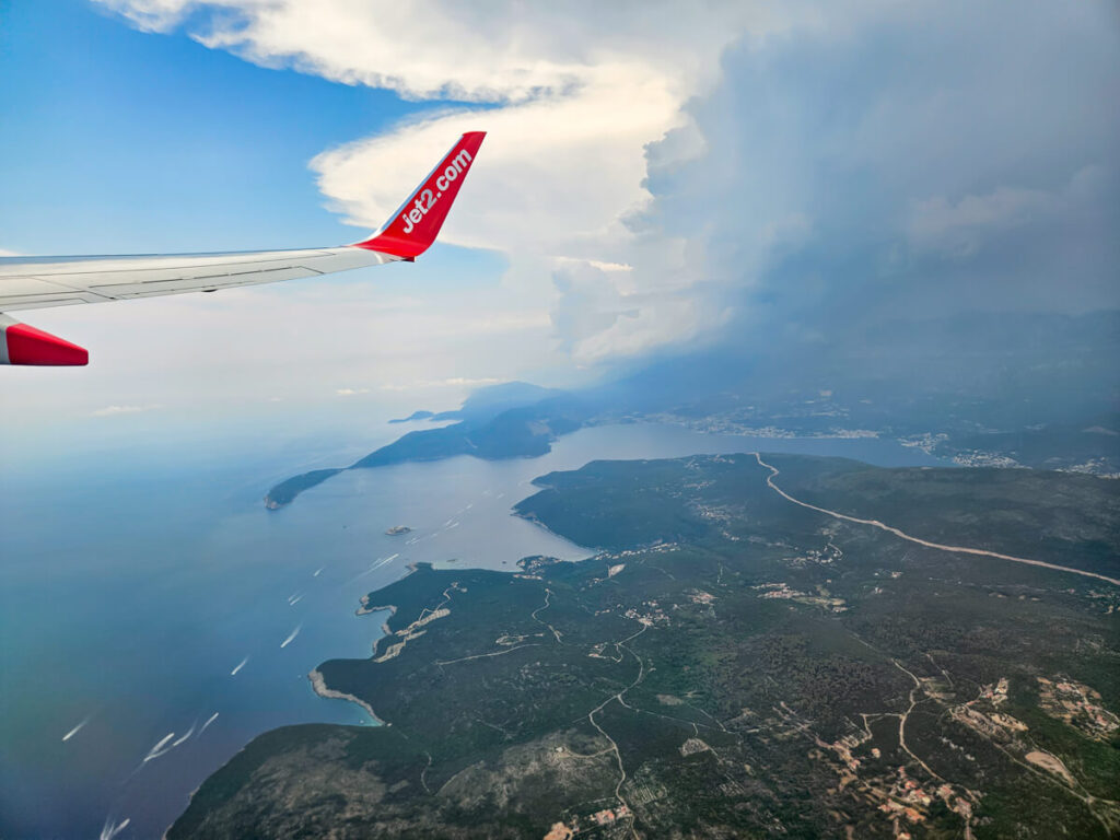 The wing of a Jet2 plane flying over the Bay of Kotor.