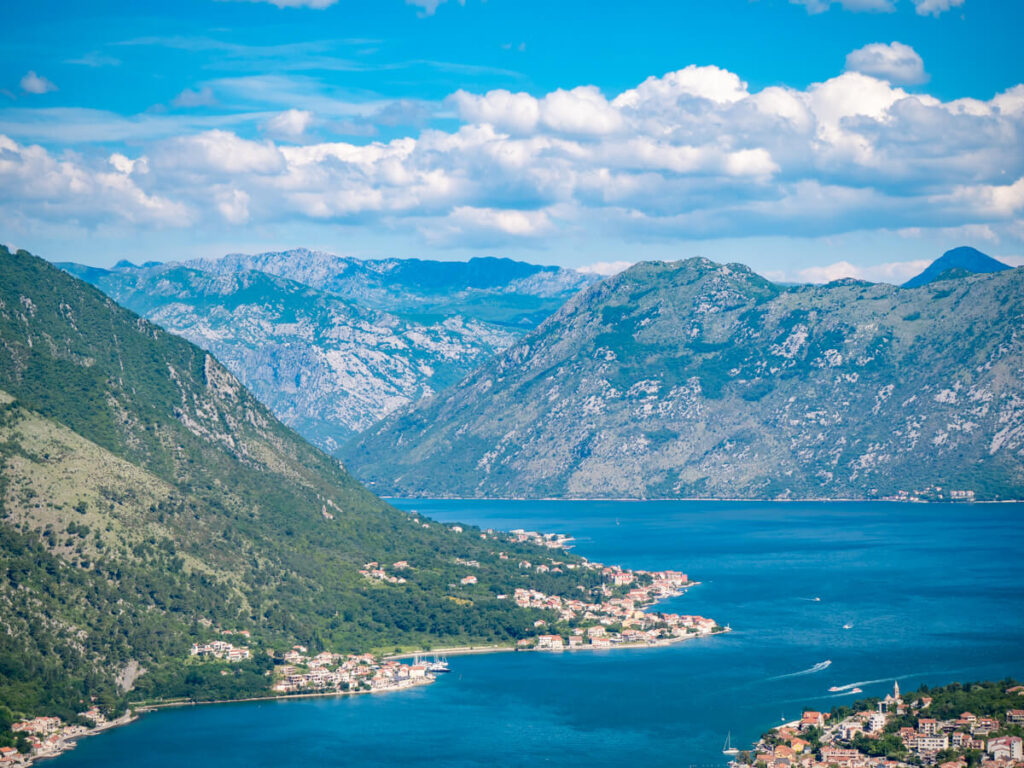 The blue waters of the Bay of Kotor snaking into the distance between imposing moutnains.