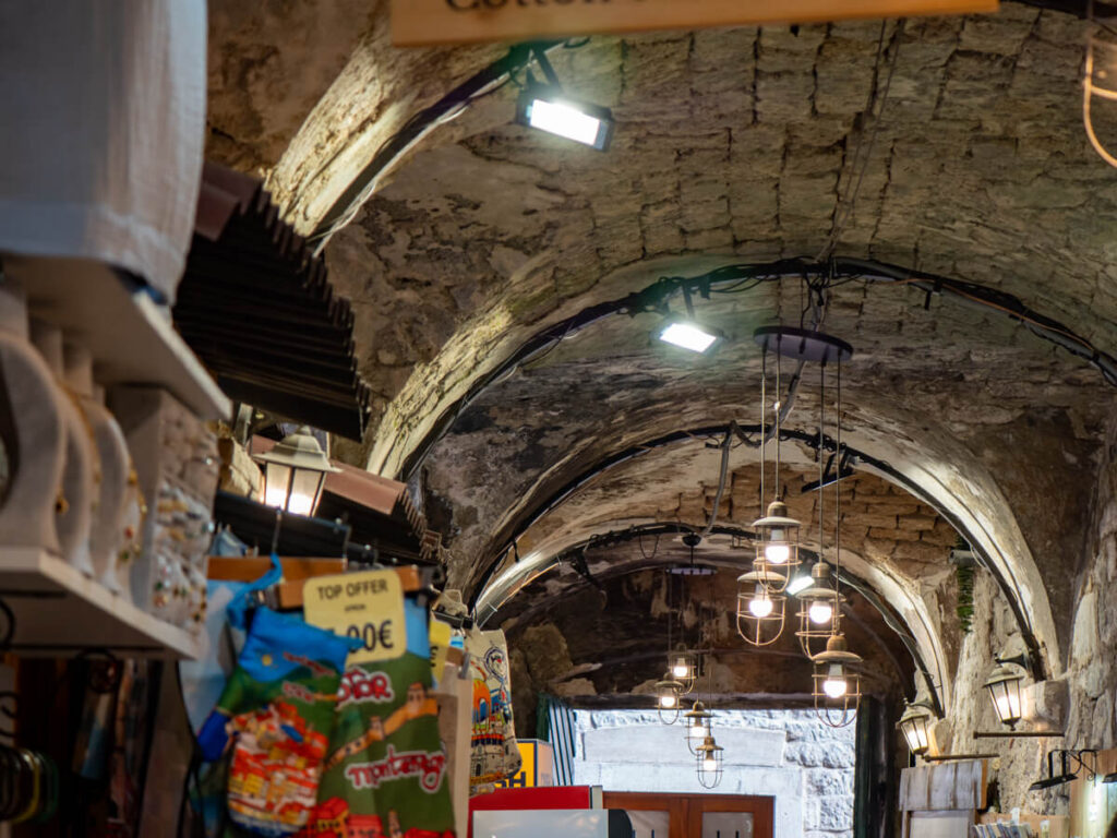 The interior of Kotor's bazaar with stalls set up under the domed stone roof.