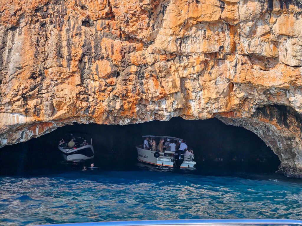 Two speedboats inside the entrance to the Blue Cave in Montenegro.