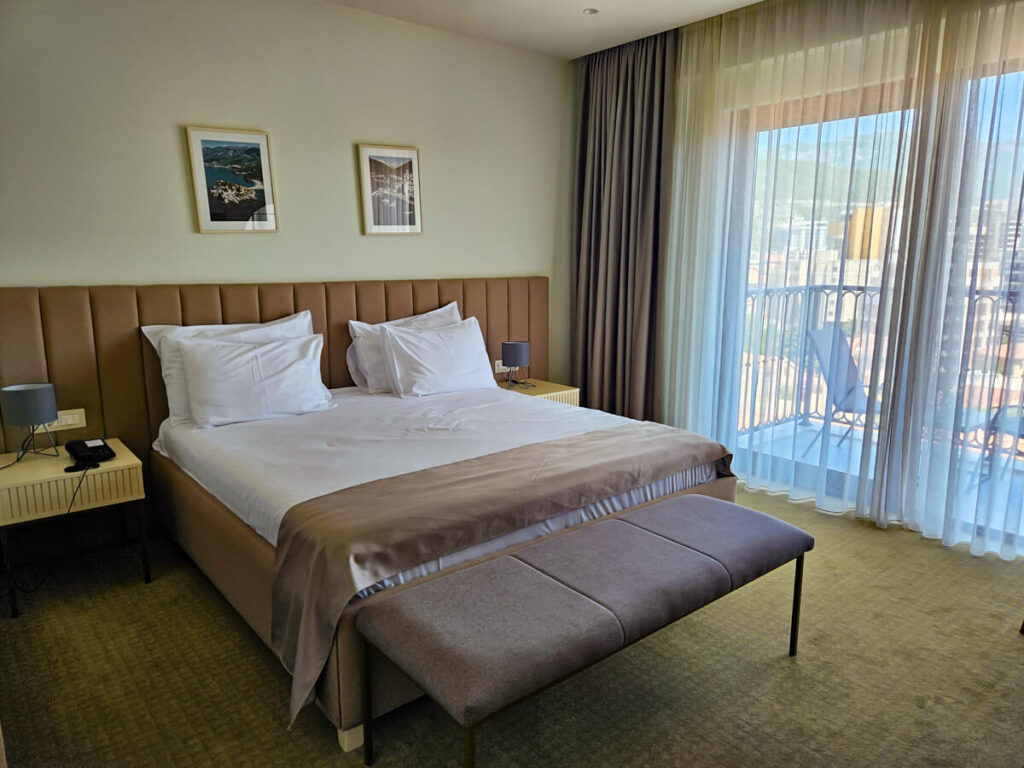 A bed in a comfortable hotel room in Budva.