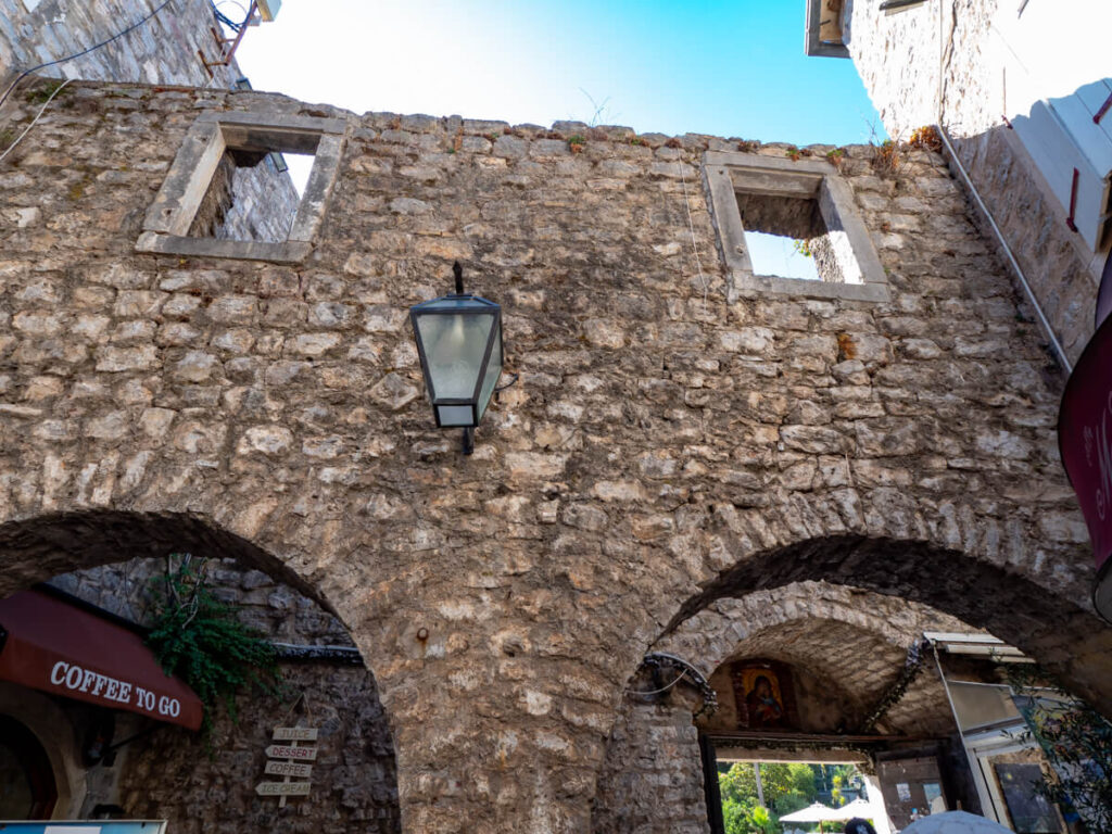 An arched stone gate in the walls around Budva Old Town.