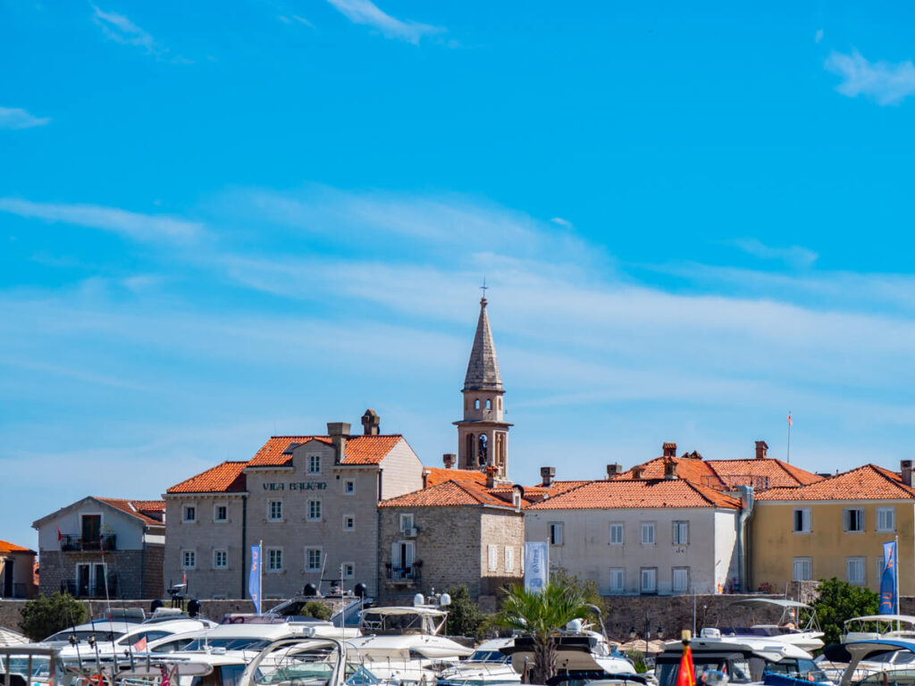 A bell tower above the red rooves of Budva Old Town.