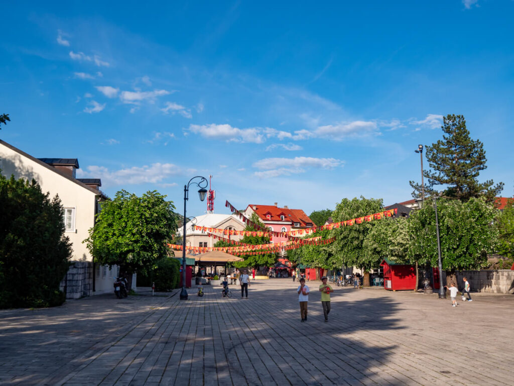 A wide paved street lined with historic buildings in Cetinje.