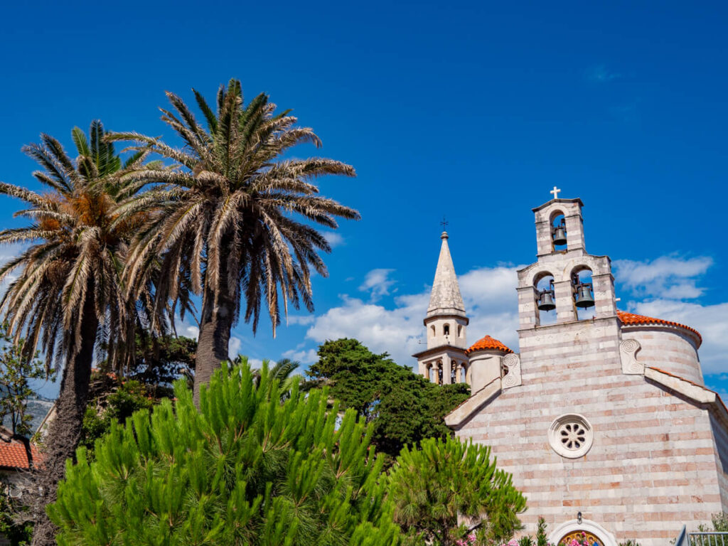 Palm trees in front of Church of Saint John the Baptist in Budva.