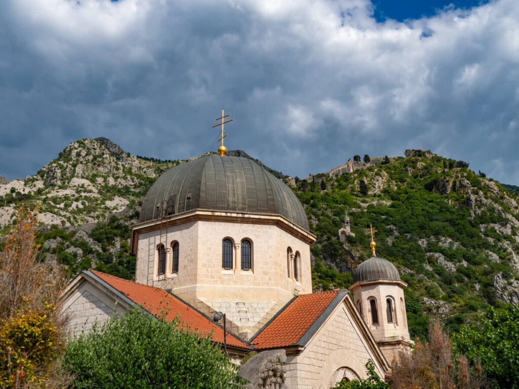 A church with domed roofs on the hills of Kotor, Montenegro.