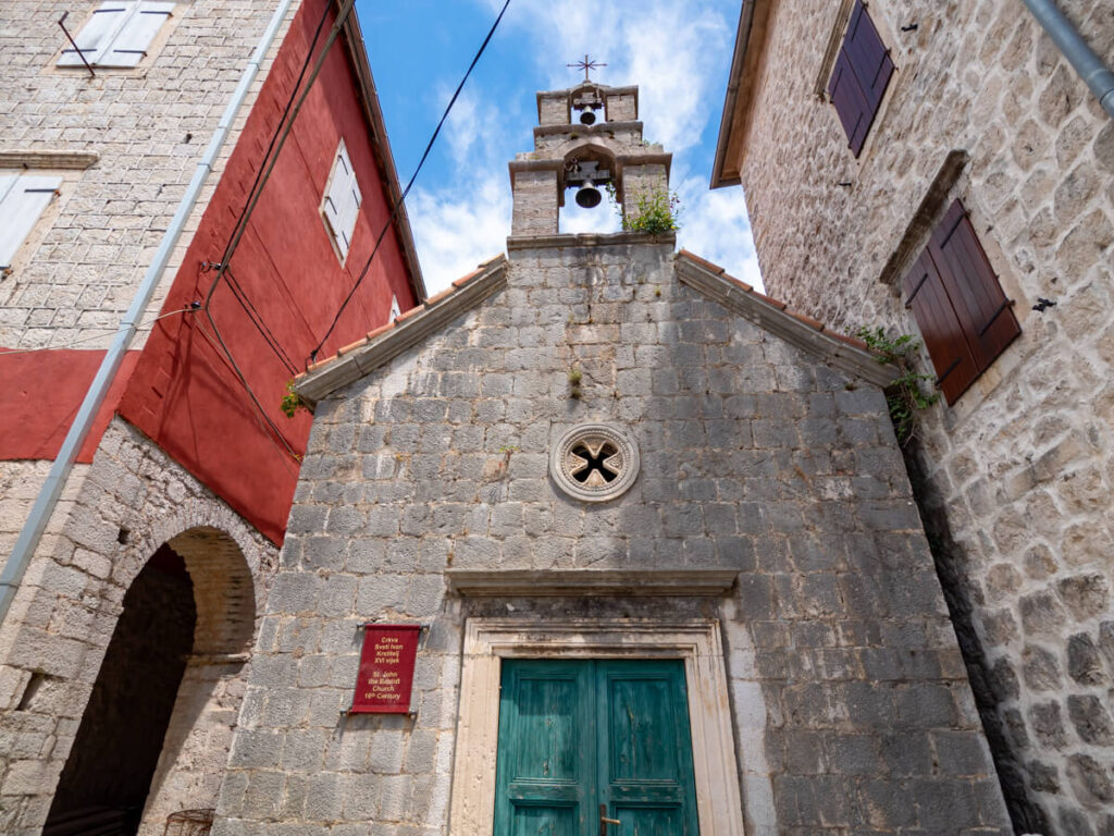 A small church tucked between stone houses in Perast.