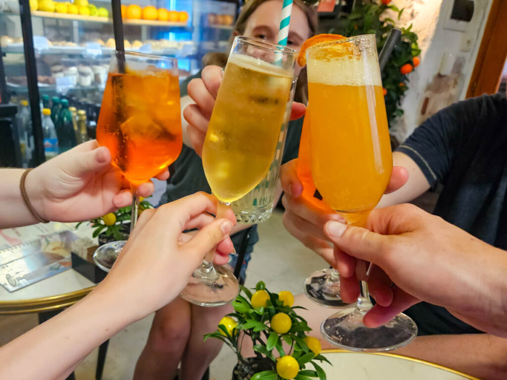 A group of cocktails being cheersed together in a bar in Kotor, Montenegro.