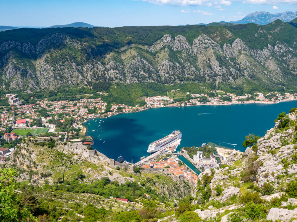 A large cruise ship docked in Kotor, viewed from the top of the Ladder of Kotor hike.
