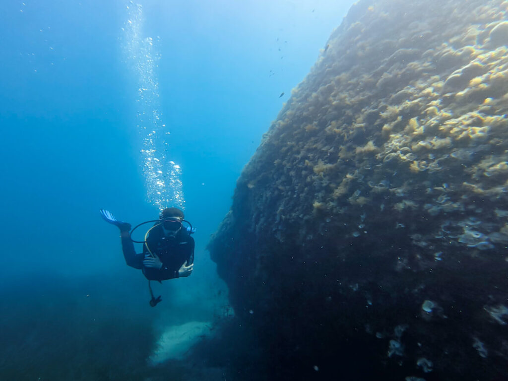 Dan SCUBA diving along the side of a coral wall in Budva, Montenegro.