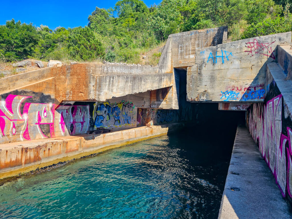 The graffitied entrance to an old submarine tunnel on the Luštica Peninsula.
