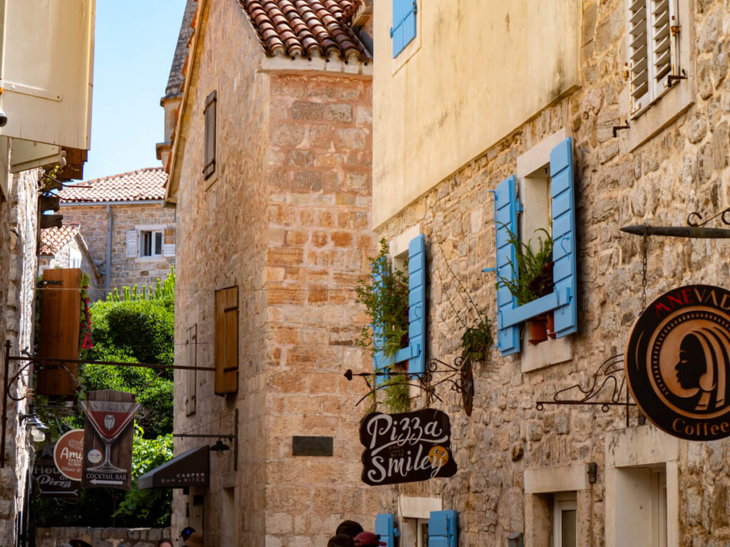 Restaurants lining a stone street in Budva Old Town.