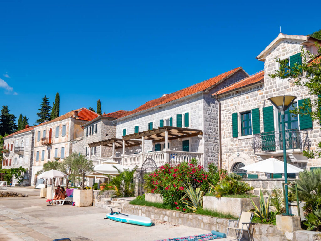 Stone houses lining the waterfront in Rose on the Luštica Peninsula.