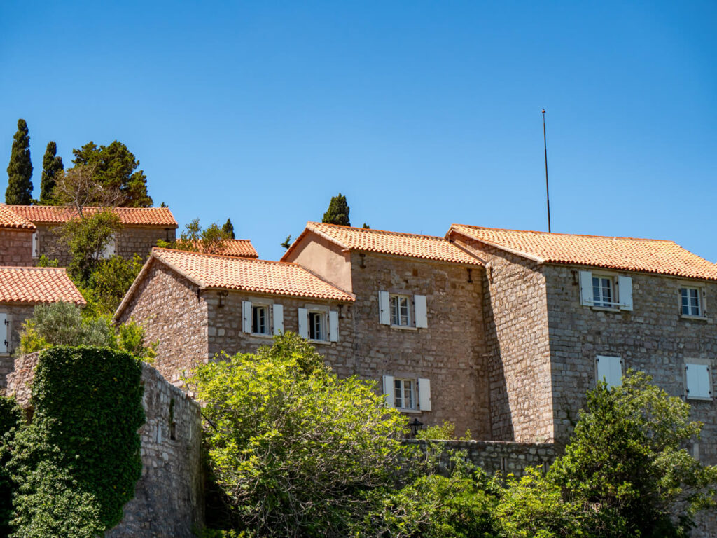 Red-rooved, stone houses on Sveti Stefan Island.