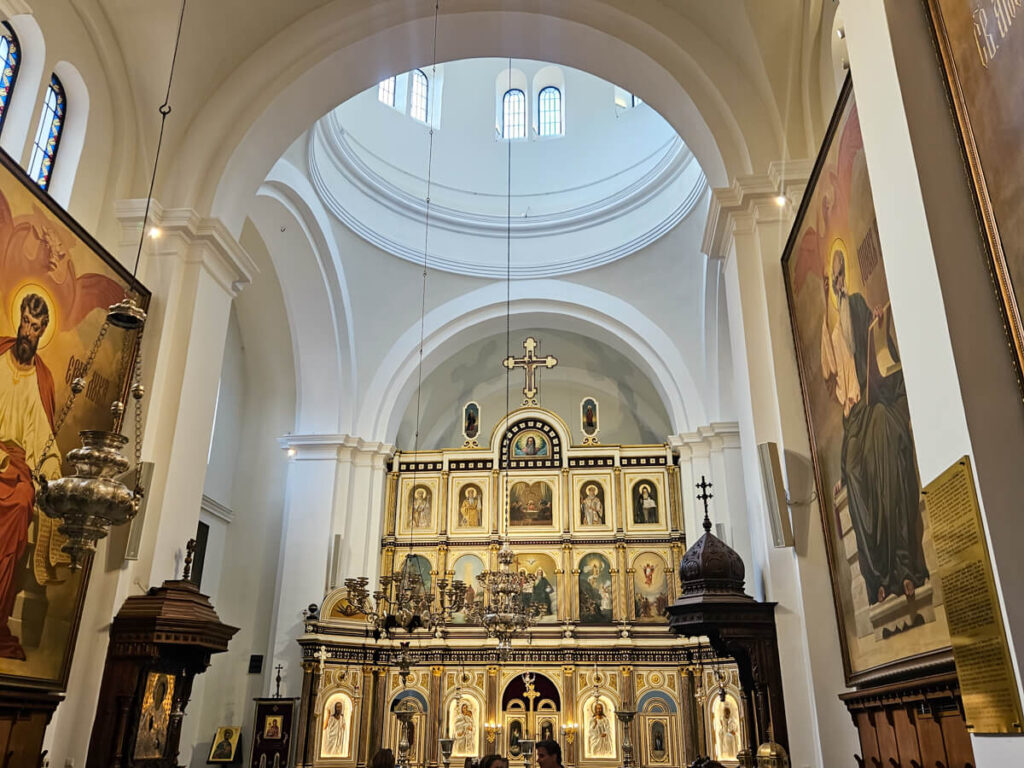 The interior of Saint Nicholas' Church in Kotor, with a grand, gold altar.