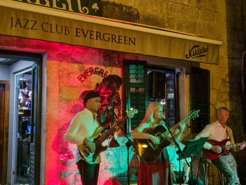 Musicians playing outside Jazz Club Evergreen in Kotor at night.