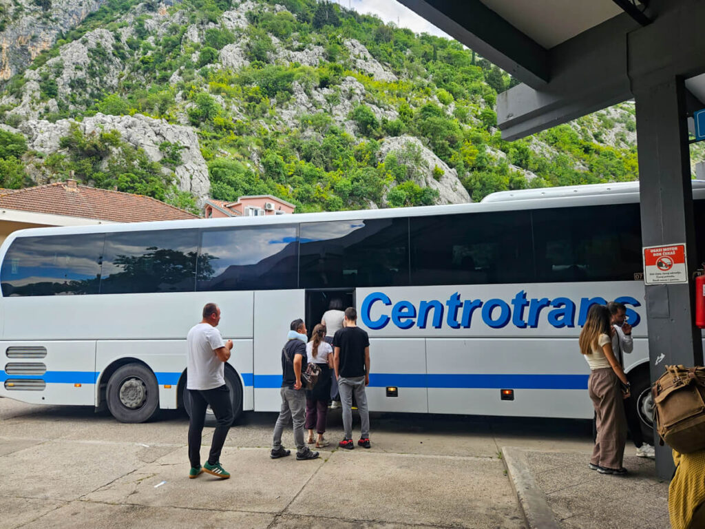 A line of passengers boarding a bus in Kotor, Montenegro.