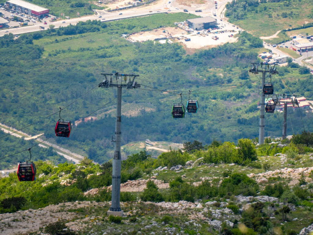 Colourful gondolas on the Kotor Cable Car on a hill above the town.