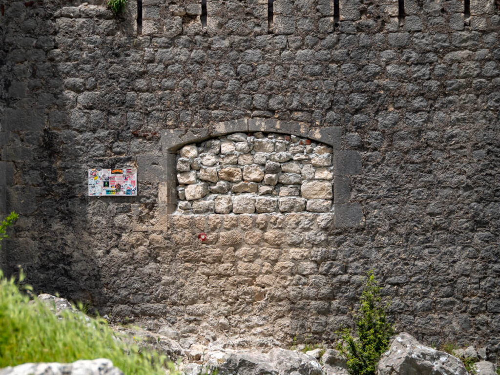 The bricked up window in a wall at the back of the San Giovanni Fortress in Kotor.