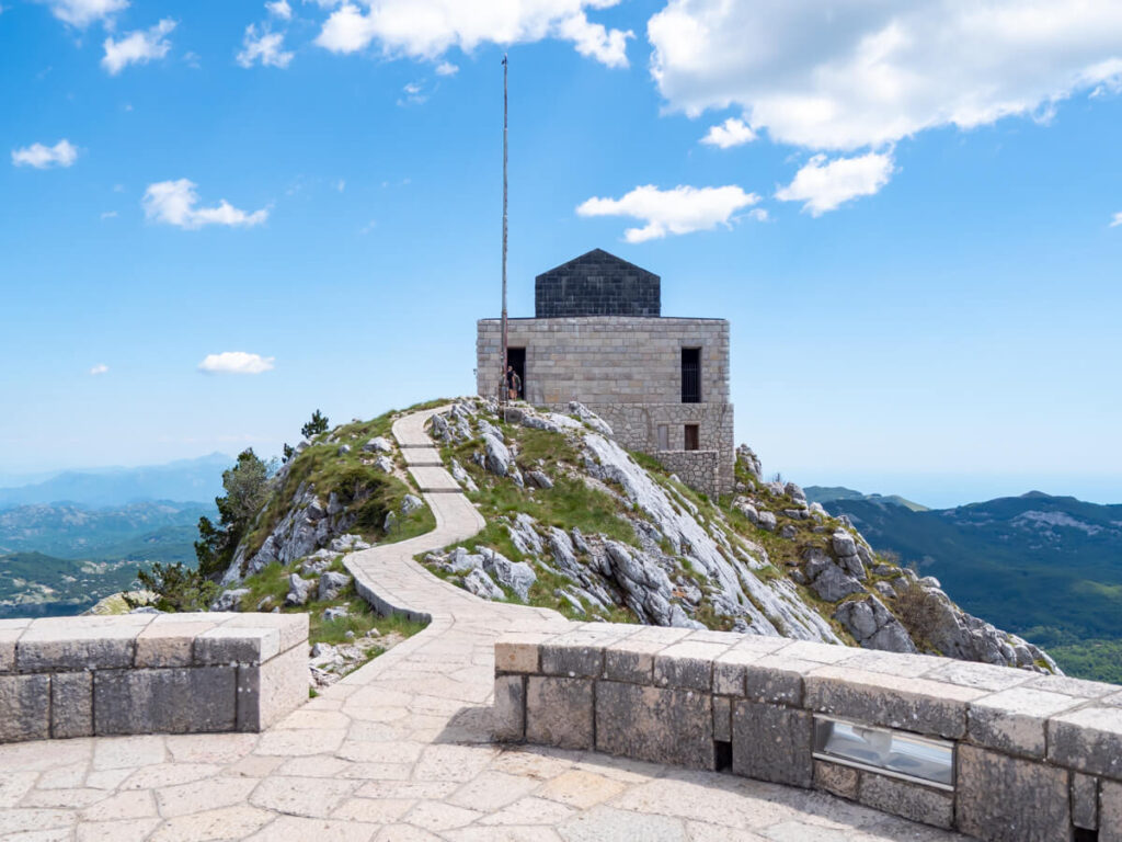 A paved path leading from the viewpoint to the mausoleum in Lovćen National Park.