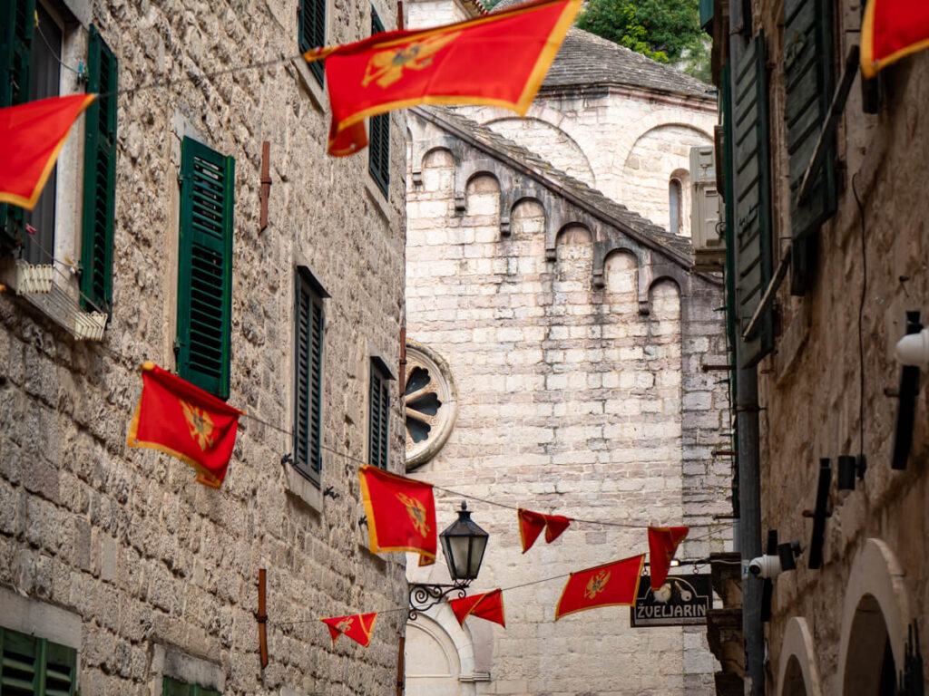 A street in Kotor decorated with red Montenegro flags in celebration of Montenegrin independence.