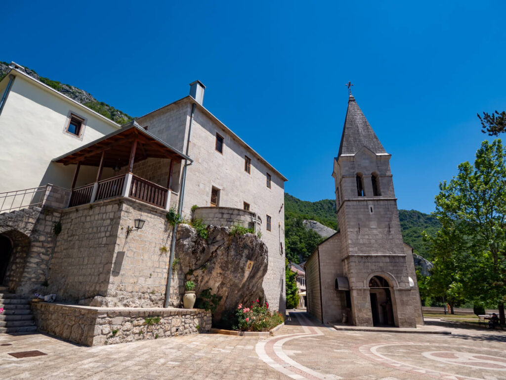 A church in a stone courtyard in the Lower Monastery of Saint Basil of Ostrog.