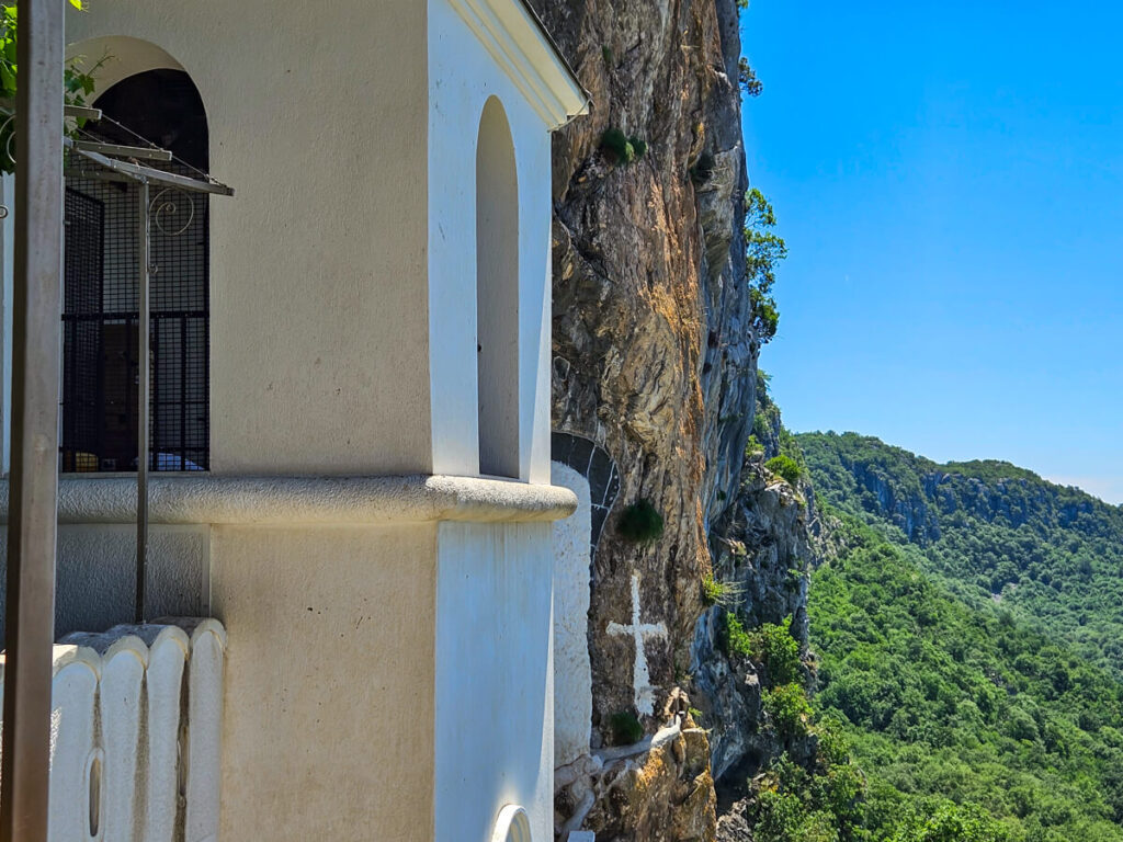 The whitewashed Ostrog Monastery, viewed from a balcony on the cliff face.