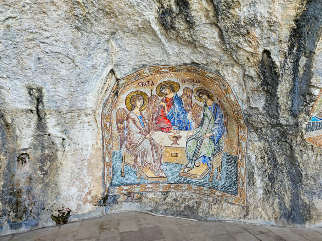 A mosaic of angels on a cliff wall in Ostrog Monastery.