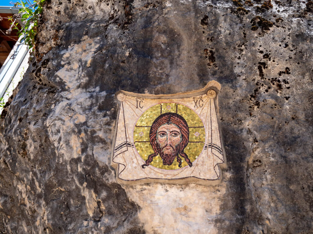 A mosaic of Jesus on a cliff wall in Ostrog Monastery.
